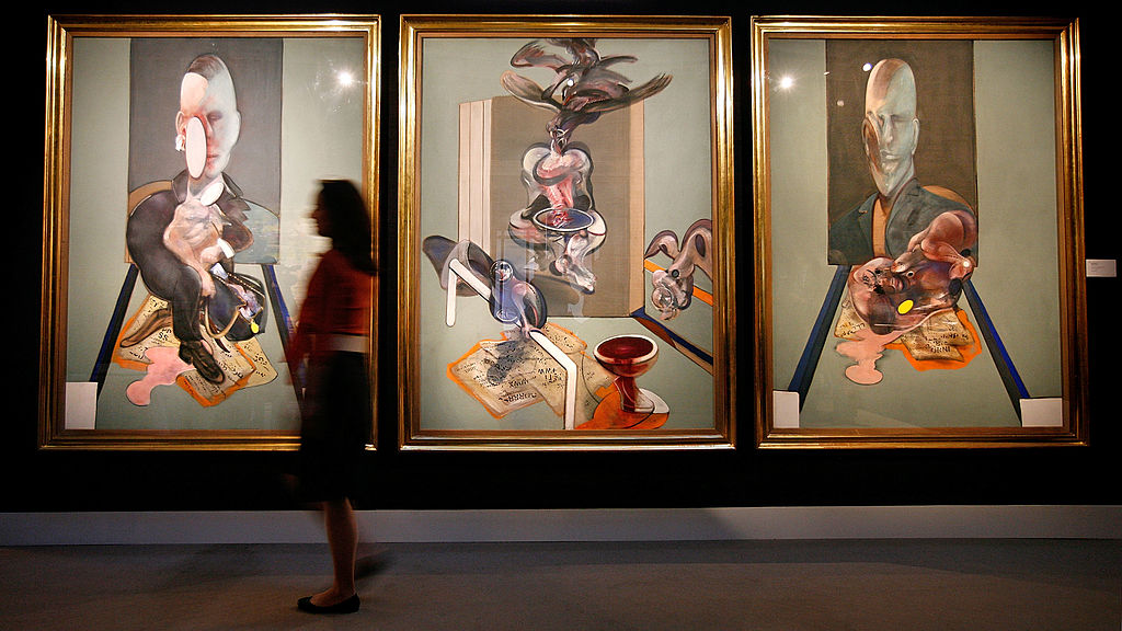 LONDON - APRIL 14:  A Sotheby's employee passes in front of Francis Bacon's triptych, 1976, on April 14, 2008, in London, England. The artwork, estimated to sell for 70 million GBP, is part of highlights from the New York Contemporary Art Sale to be shown in an exhibition from April 13 to 16, 2008. (Photo Cate Gillon/Getty Images)