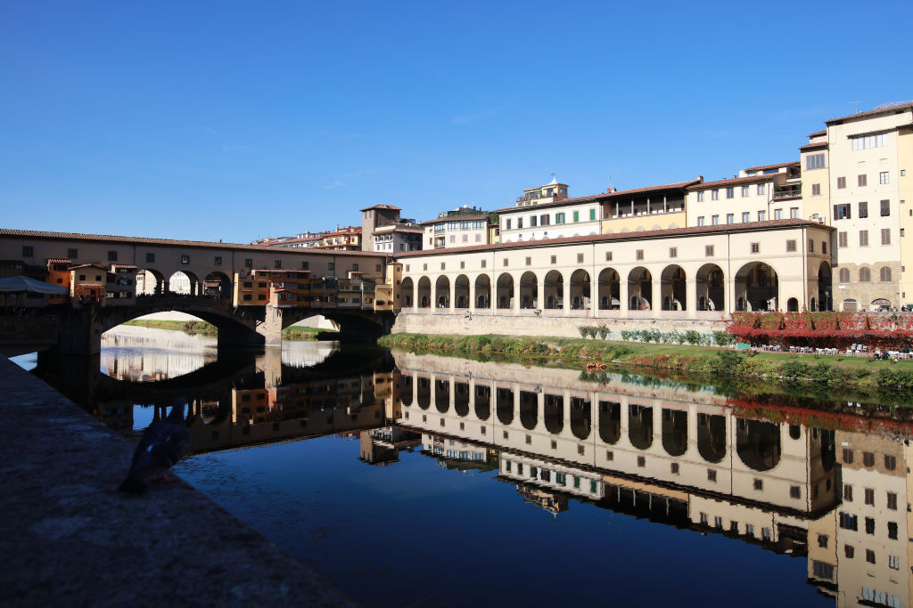 FLORENCE, ITALY - NOVEMBER 01: The Ponte Vecchio (Old Bridge) is a medieval bridge spanning the river Arno in Florence. It is one of the few remaining bridges with houses built upon. The Vasari corridor that runs over the houses connects the Uffizi with the Pitti Palace on the other side of the river. Florence, Italy, 1st November 2017. Photo by Tim Clayton/Corbis via Getty Images)"n