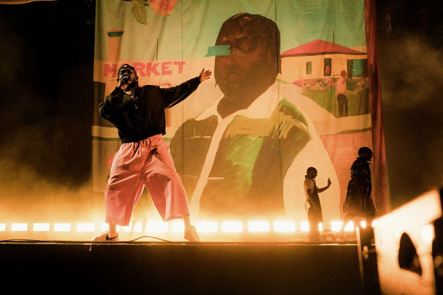 Kendrick Lamar performs in front of a reproduction of Henry Taylor's 2006 painting  Fatty at a recent music festival.