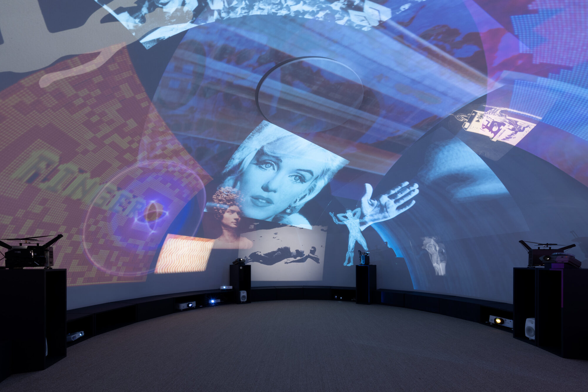 installation shot from inside a dome with various images projected onto the inside ceiling